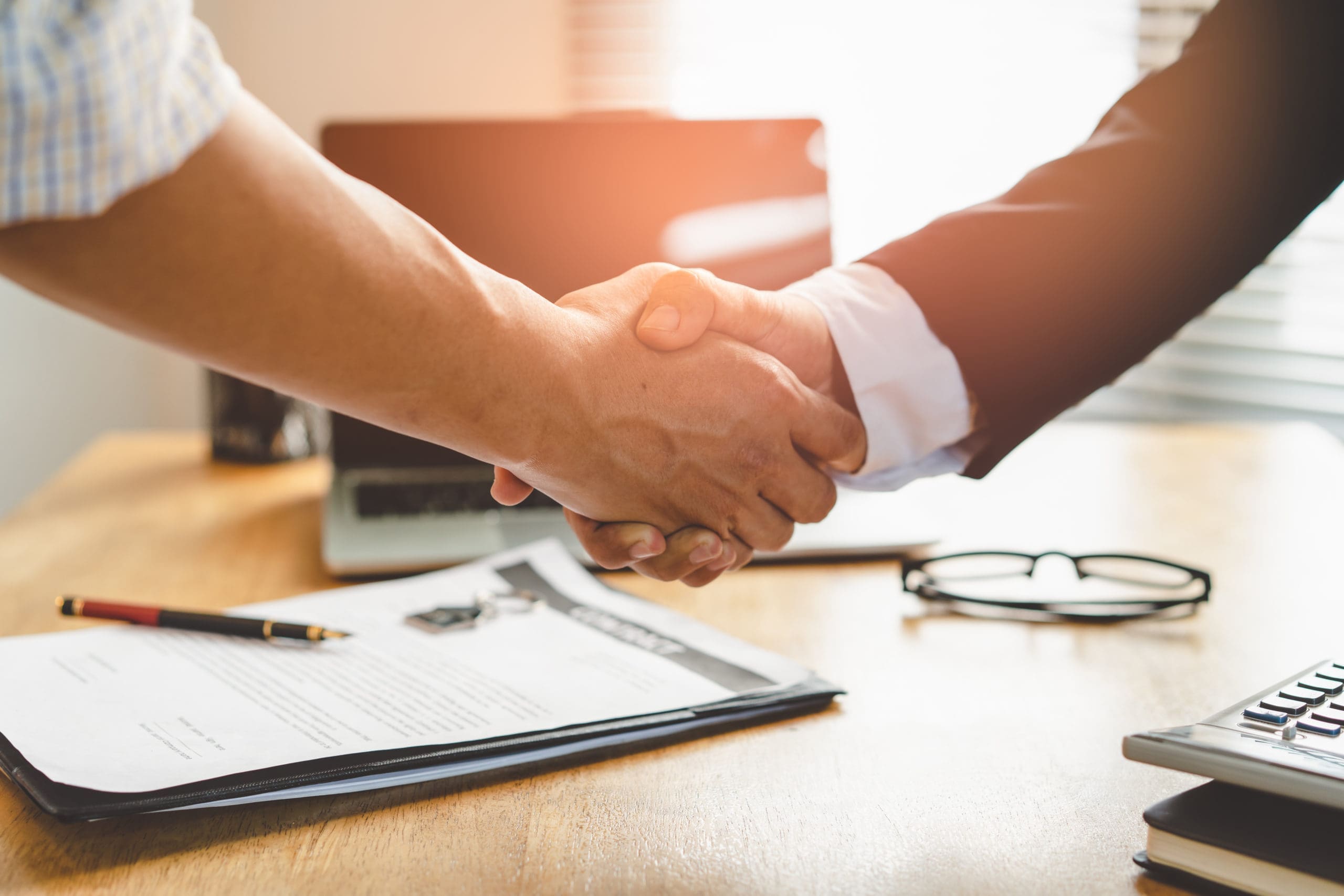 Partners corporate relationship concept. Close up handshake of business people in meeting attendance.